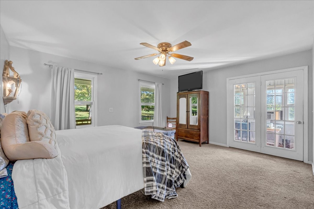 487 County Line Road Lynchburg, TN 37352 - Photo 32 of 63 a bedroom with a large bed and a chandelier
