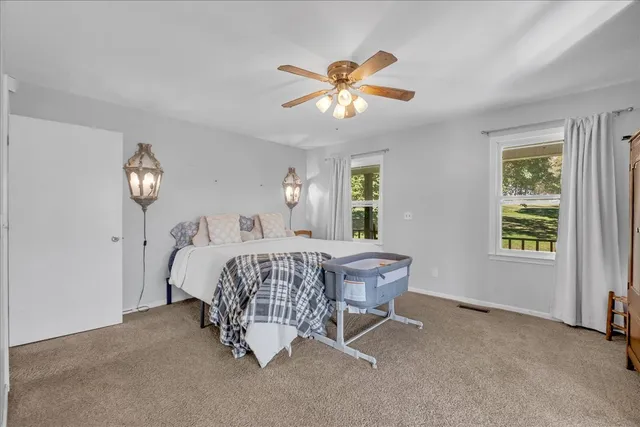a view of a livingroom with furniture a ceiling fan and window