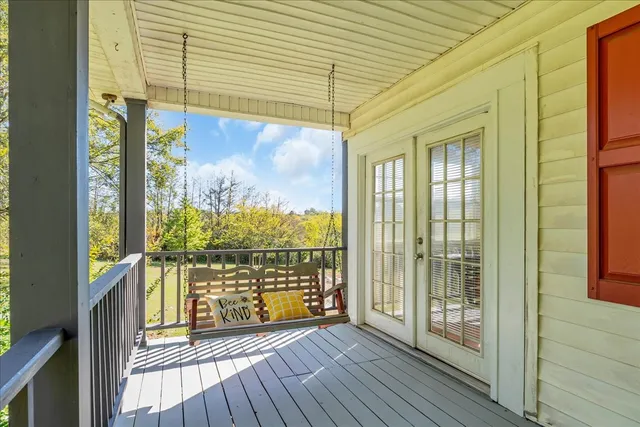 a view of balcony with wooden floor and fence