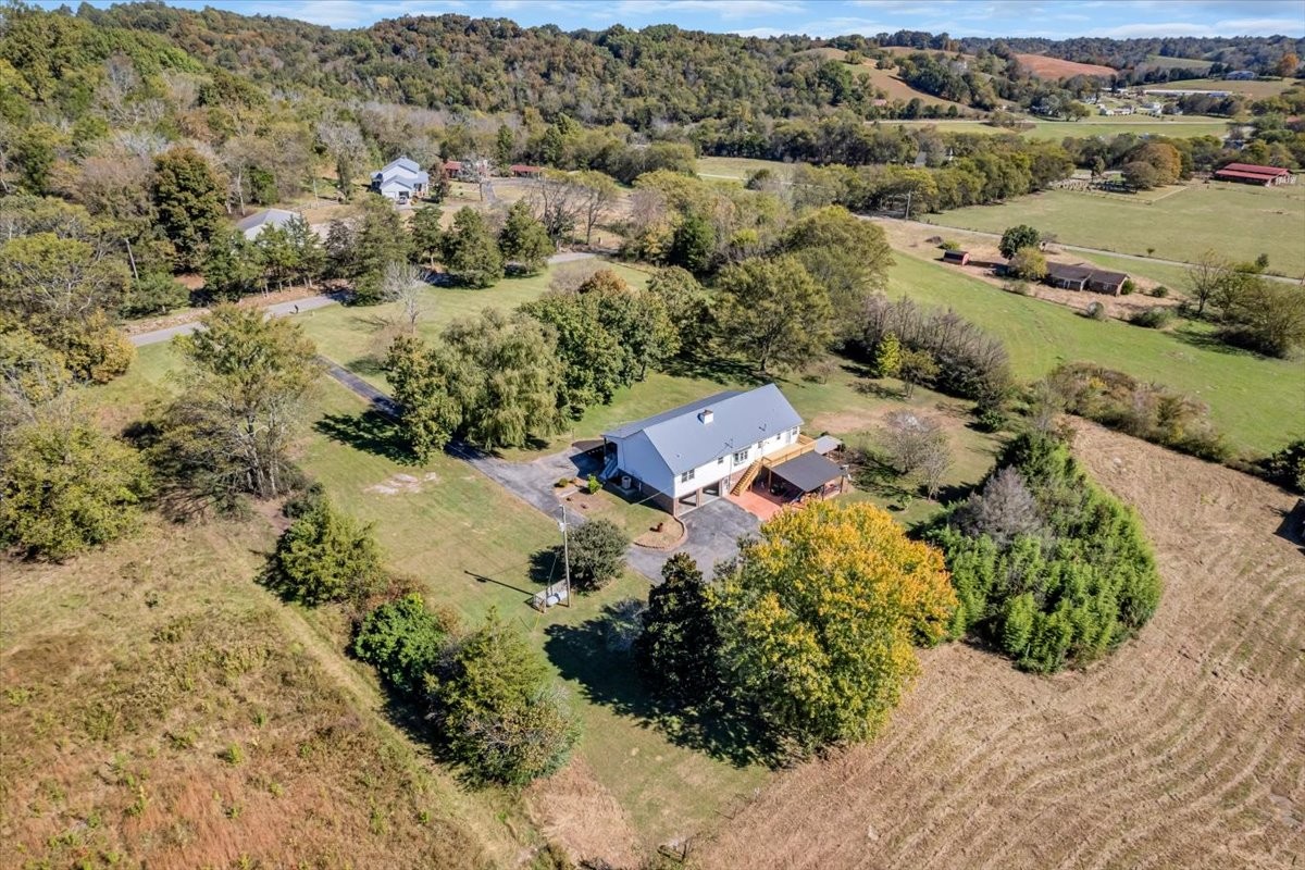 487 County Line Road Lynchburg, TN 37352 - Photo 59 of 63 an aerial view of green landscape with trees houses and mountain view