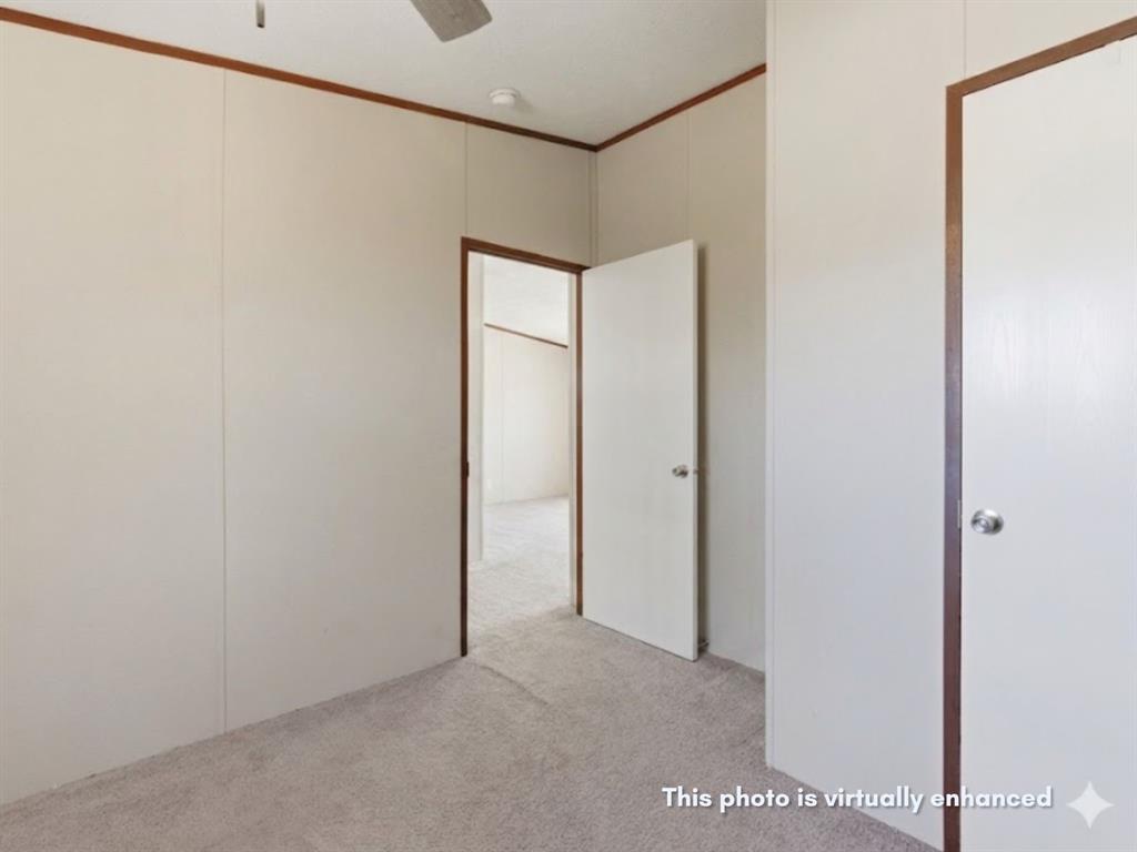 2722 Denver Road Sunset, TX 76270 - Photo 14 of 19 Carpeted interior room with light-toned walls and contrasting wood trim