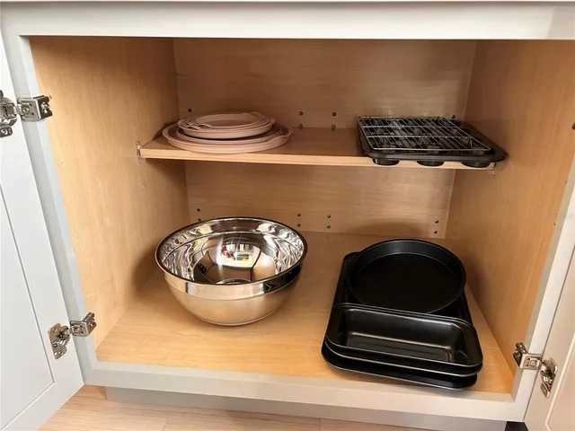 a kitchen with a sink and a stove with wooden floor