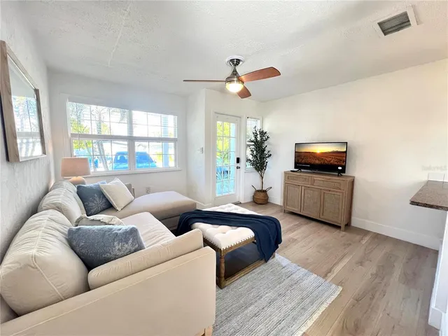 a living room with furniture and kitchen view