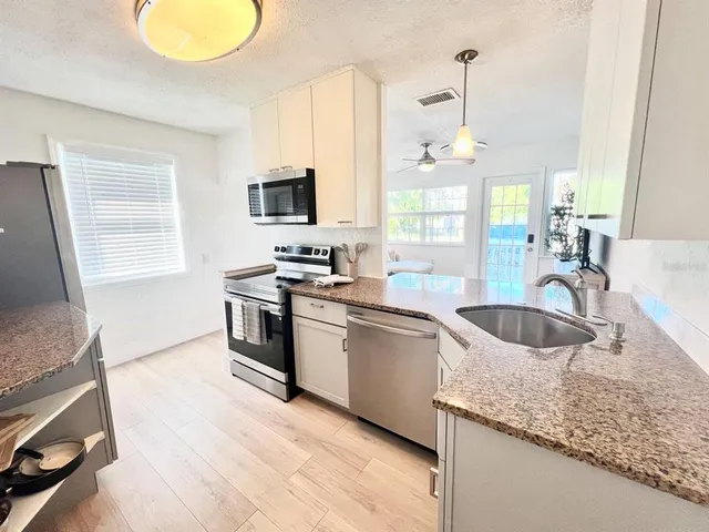 a bedroom with a bed and ceiling fan