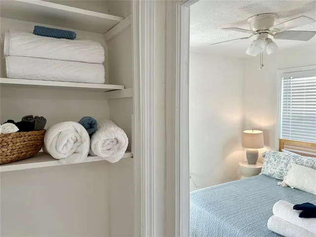 a bedroom with a bed and a painting on the wall