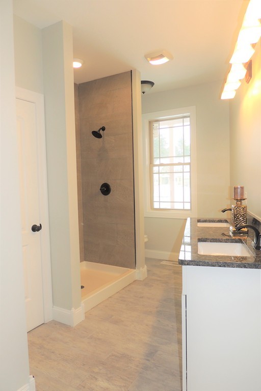 Lot 77 Alwin Place Springfield, MA 01128 - Photo 12 of 30 a bathroom with a granite countertop sink a shower and a mirror