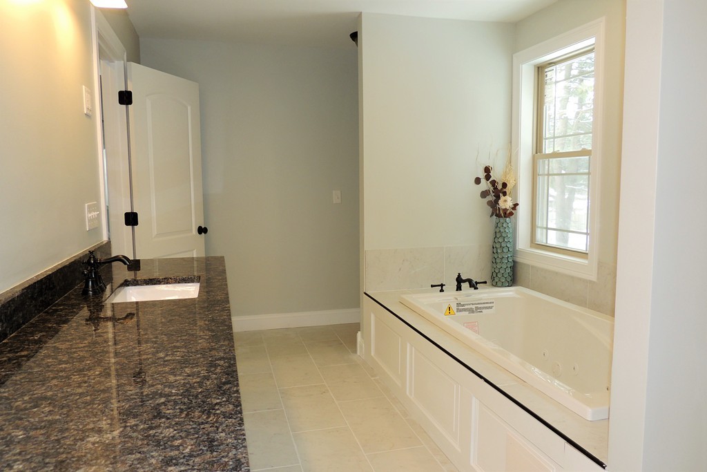 Lot 77 Alwin Place Springfield, MA 01128 - Photo 25 of 30 a bathroom with a tub sink and mirror