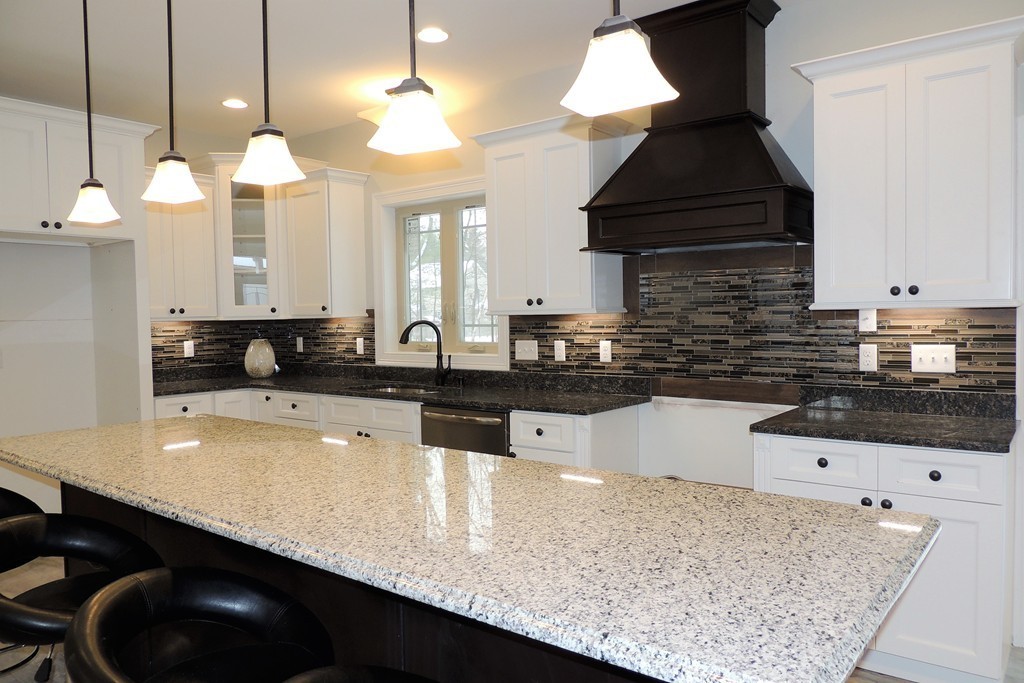 Lot 77 Alwin Place Springfield, MA 01128 - Photo 9 of 30 a kitchen with granite countertop a sink a stove and cabinets