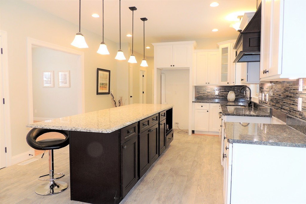 Lot 77 Alwin Place Springfield, MA 01128 - Photo 10 of 30 a kitchen with stainless steel appliances granite countertop a sink a refrigerator and a stove