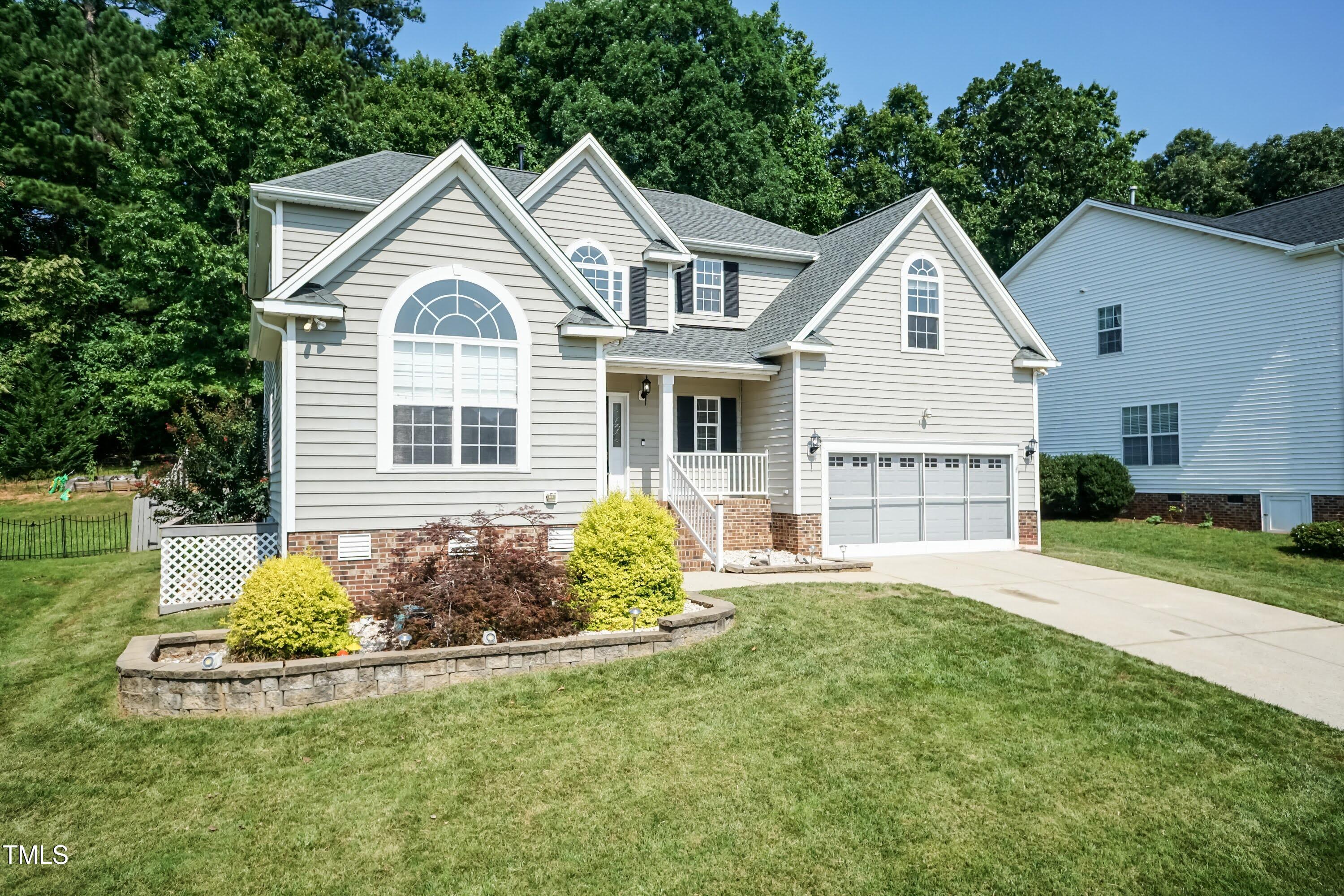 212 Mickleson Ridge Drive Raleigh, NC 27603 - Photo 2 of 58 a front view of a house with a yard