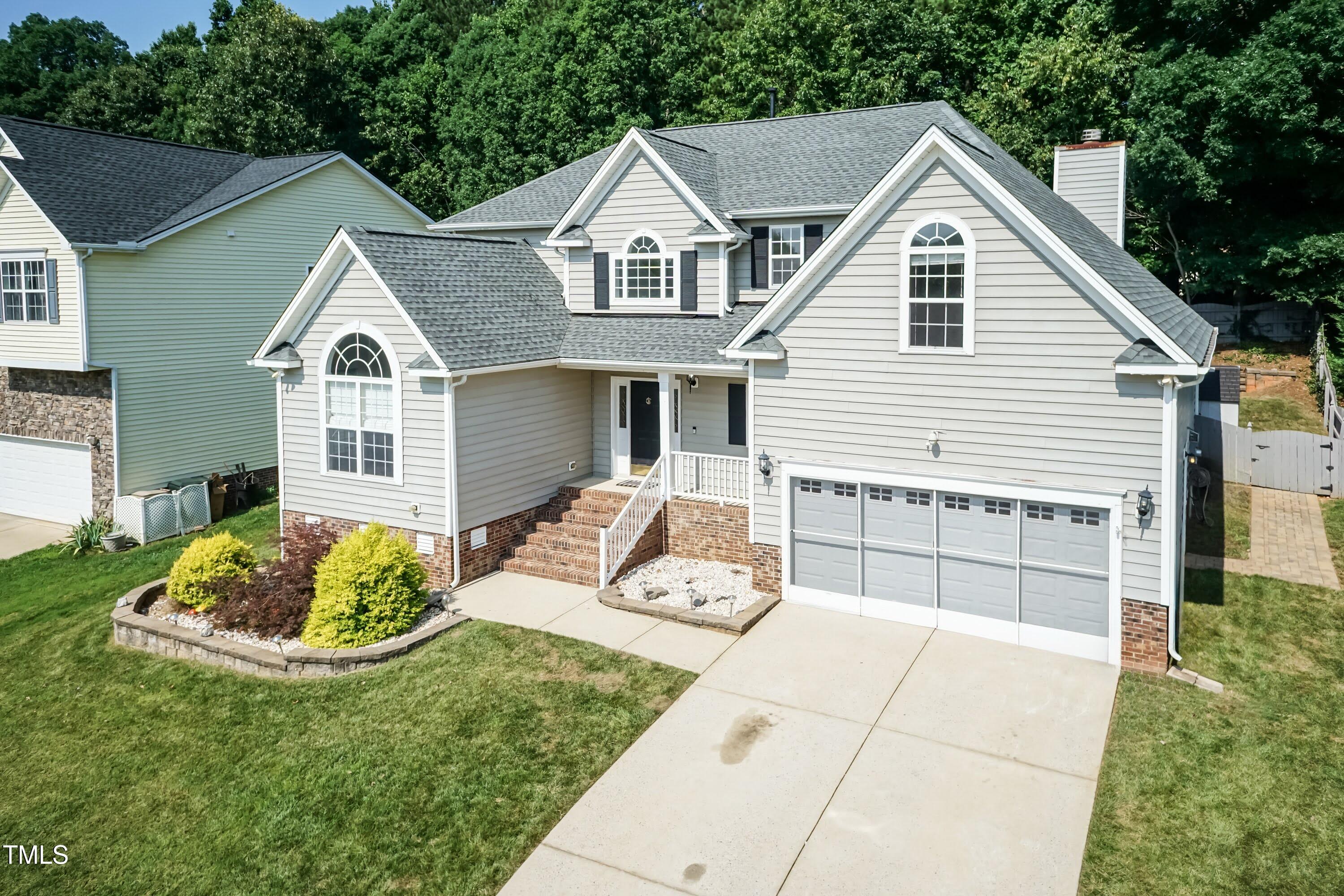 212 Mickleson Ridge Drive Raleigh, NC 27603 - Photo 46 of 58 a front view of a house with a yard and garage