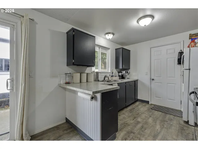 a kitchen with kitchen island a sink stainless steel appliances and cabinets