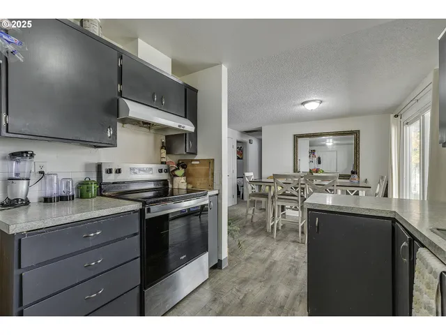 a kitchen with lots of counter top space and stainless steel appliances