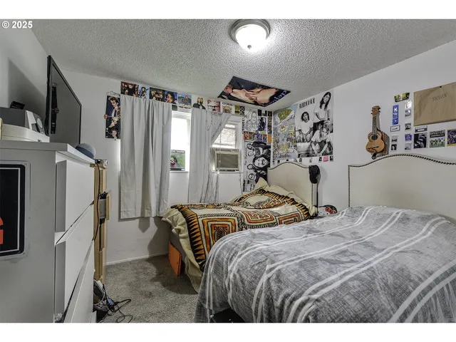 a bedroom with bed and a large mirror