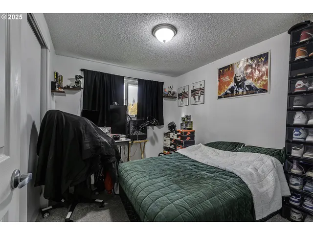 a bedroom with a bed a mirror and a flat screen tv