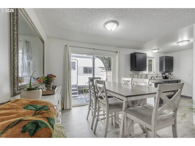 a view of a dining room with furniture and a flat screen tv