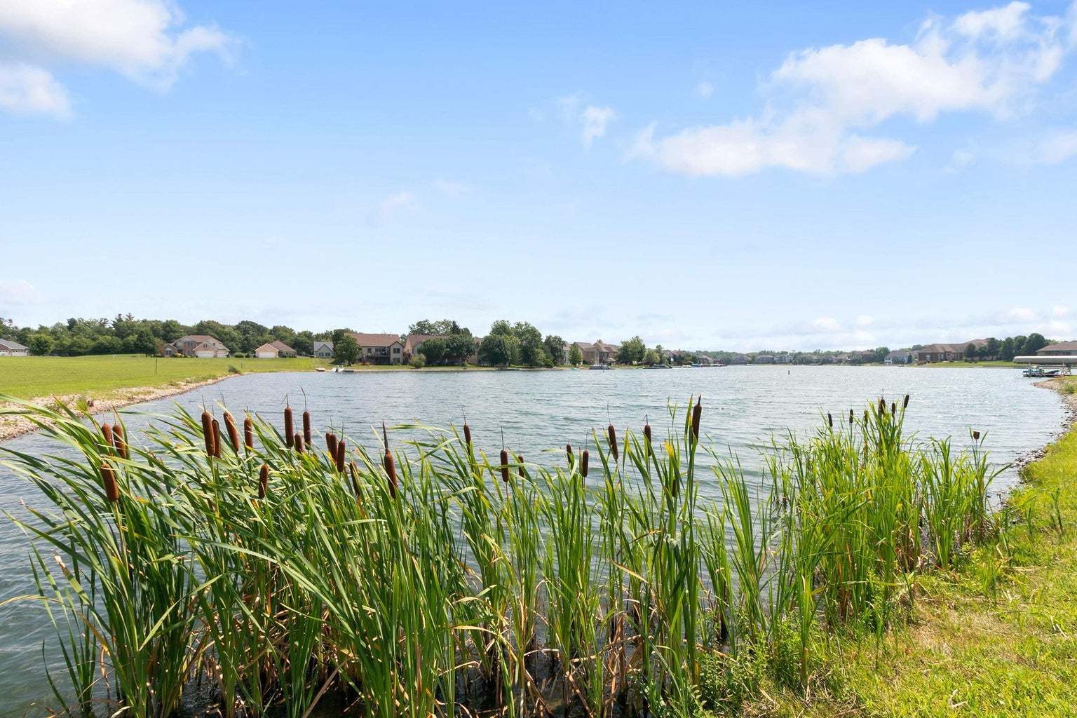 9275 Doubletree Drive South Winfield, IN 46307 - Photo 11 of 30 a view of a lake with houses in the back