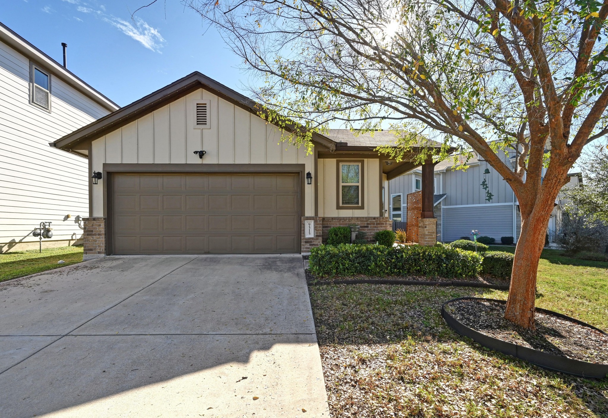 9515 Tanager Way Austin, TX 78748 - Photo 1 of 1 Ranch-style house with brick siding, board and batten siding, driveway, and a garage