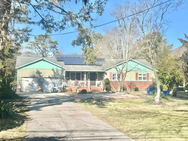 a view of a house with a yard and sitting area