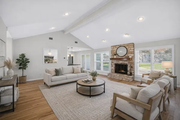 a living room with furniture a fireplace and a table