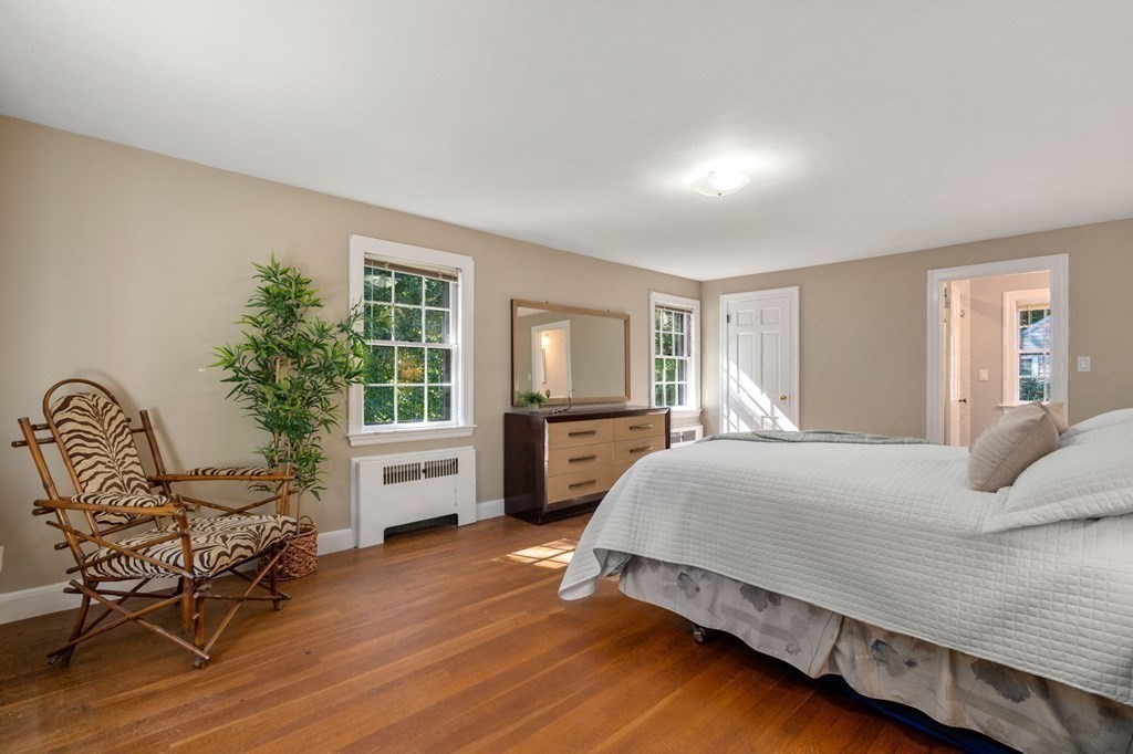 580 Quinobequin Road Newton, MA 02468 - Photo 13 of 25 a bedroom with a bed and windows