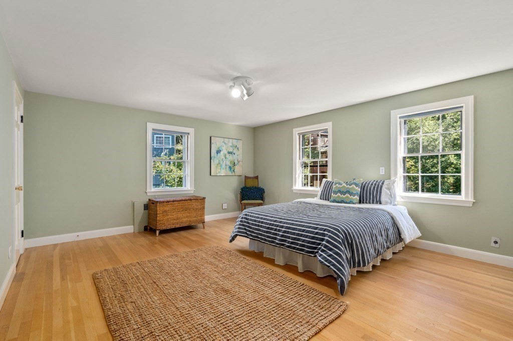 580 Quinobequin Road Newton, MA 02468 - Photo 15 of 25 a bedroom with a bed and window