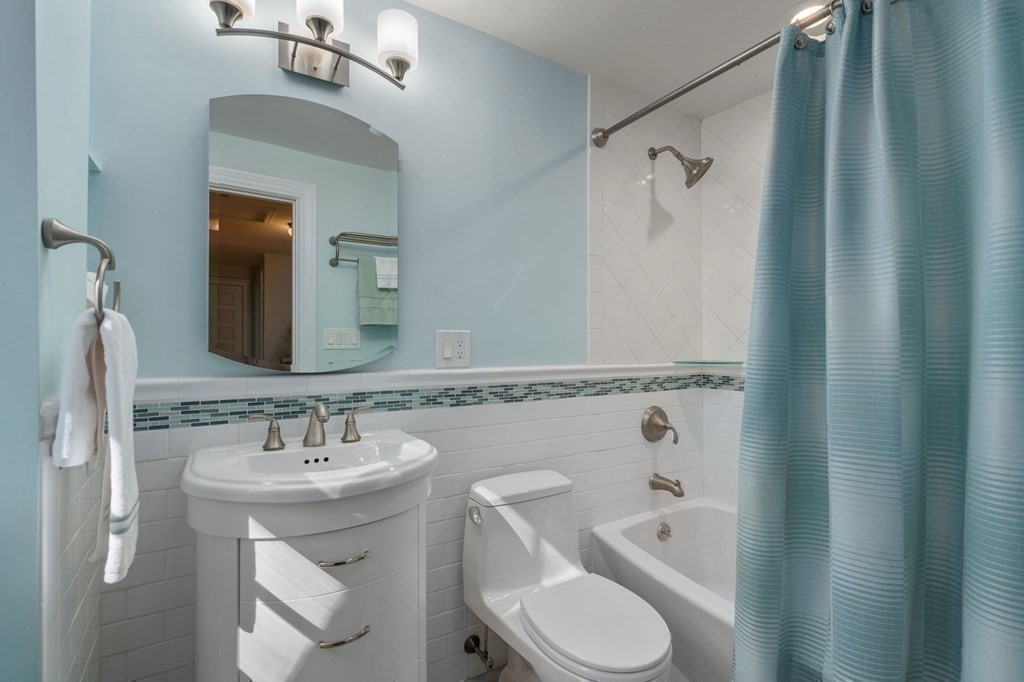580 Quinobequin Road Newton, MA 02468 - Photo 19 of 25 a bathroom with a sink toilet and shower