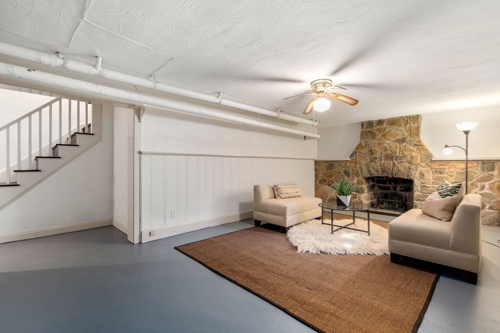 580 Quinobequin Road Newton, MA 02468 - Photo 20 of 25 a living room with furniture and a fireplace