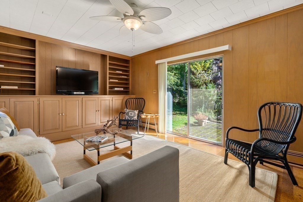 580 Quinobequin Road Newton, MA 02468 - Photo 4 of 25 a living room with furniture and a flat screen tv