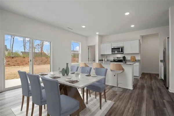 a view of a dining room with furniture window and wooden floor