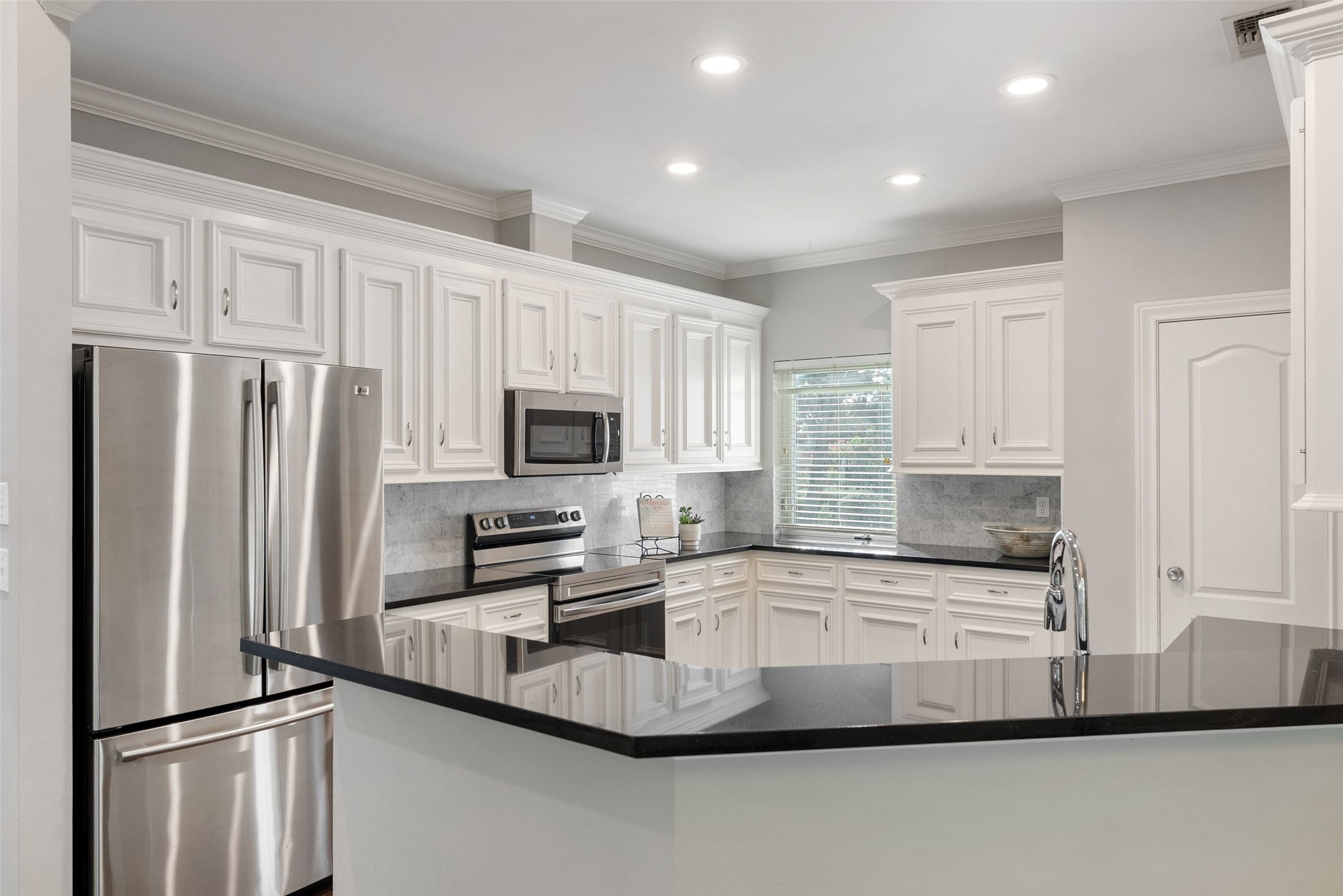 120 Copperleaf Road Lakeway, TX 78734 - Photo 11 of 30 A pristine kitchen space features sleek stainless steel appliances and abundant white cabinetry.