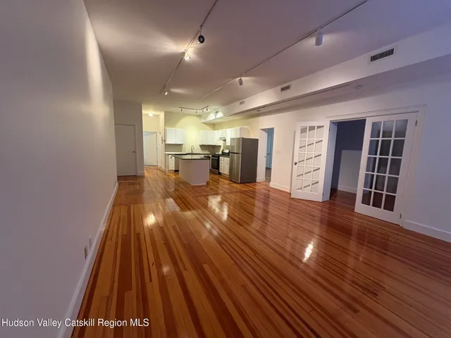 a view of a room with wooden floor