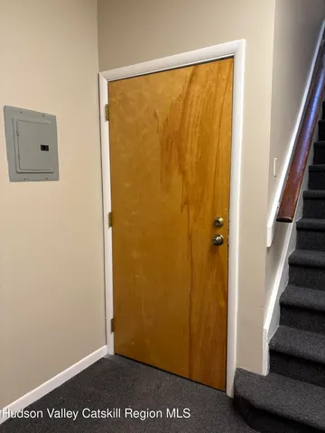 a view of a small space with wooden floor and a window