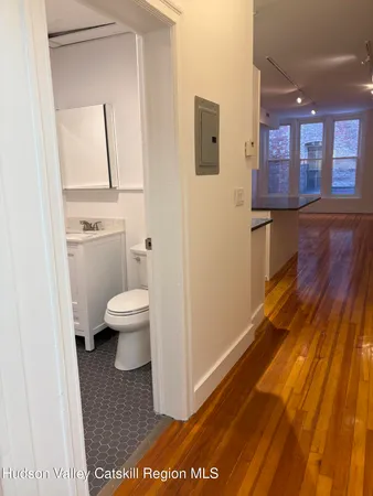 a bathroom with a toilet a sink and a mirror