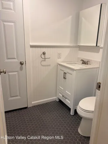 a bathroom with a toilet a sink and a vanity