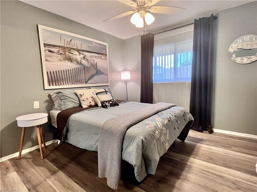 186 Harrison Road, Unit H4 Naples, FL 34112 - Photo 12 of 34 Guest Bedroom featuring vinyl plank flooring, large closet, window and a ceiling fan