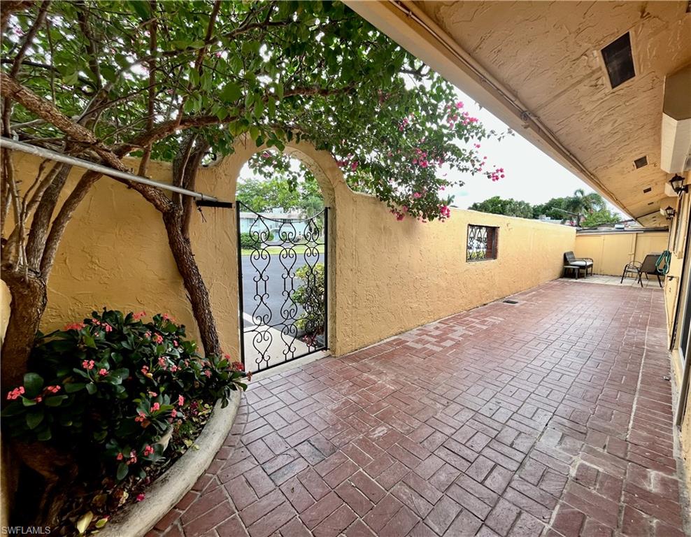 186 Harrison Road, Unit H4 Naples, FL 34112 - Photo 2 of 34 View of patio with a gate