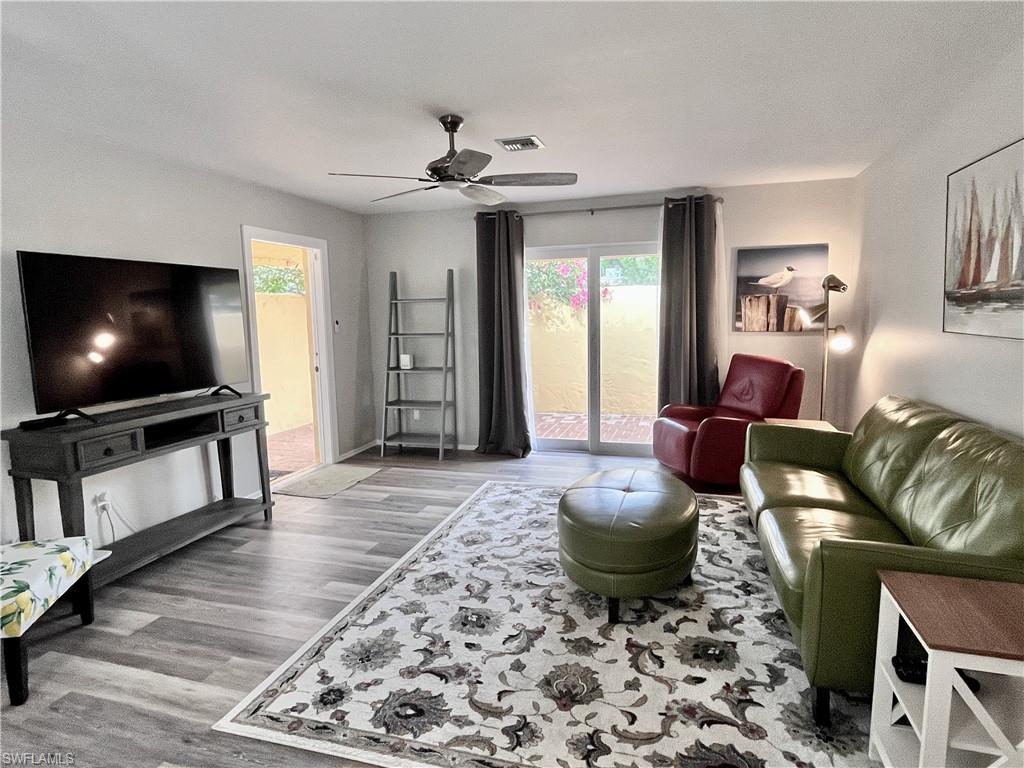 186 Harrison Road, Unit H4 Naples, FL 34112 - Photo 3 of 34 Living room with plenty of natural light, light wood finished floors, and ceiling fan