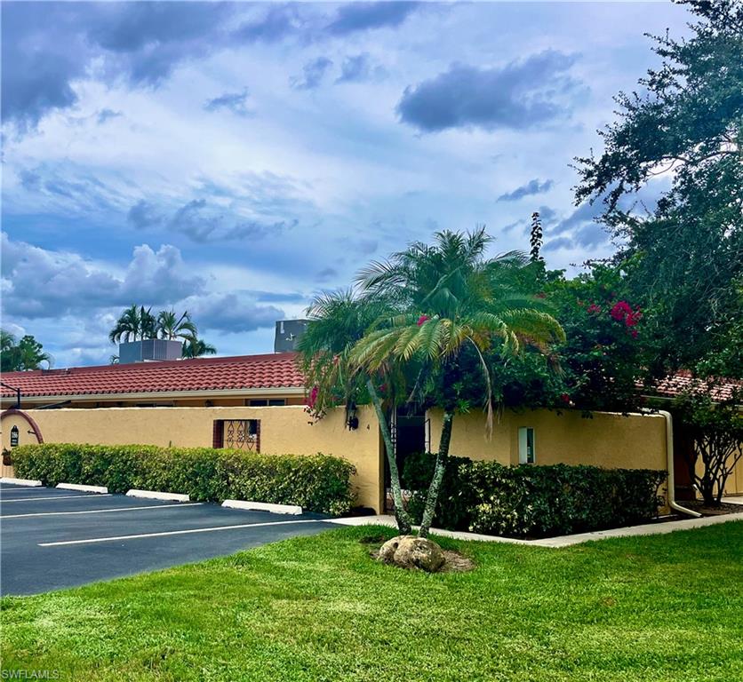 186 Harrison Road, Unit H4 Naples, FL 34112 - Photo 33 of 34 View of property featuring uncovered parking