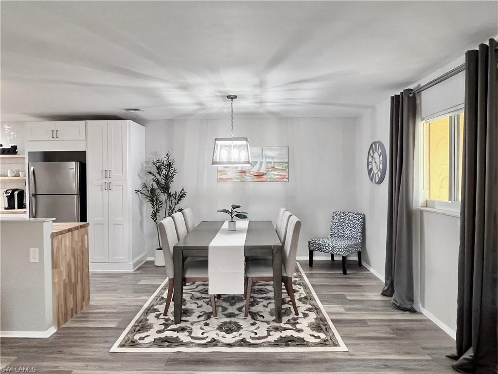 186 Harrison Road, Unit H4 Naples, FL 34112 - Photo 5 of 34 Dining space featuring light wood-style floors and baseboards