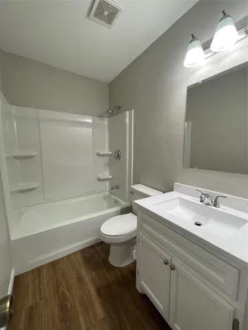 a bathroom with a double vanity sink toilet mirror and bathtub
