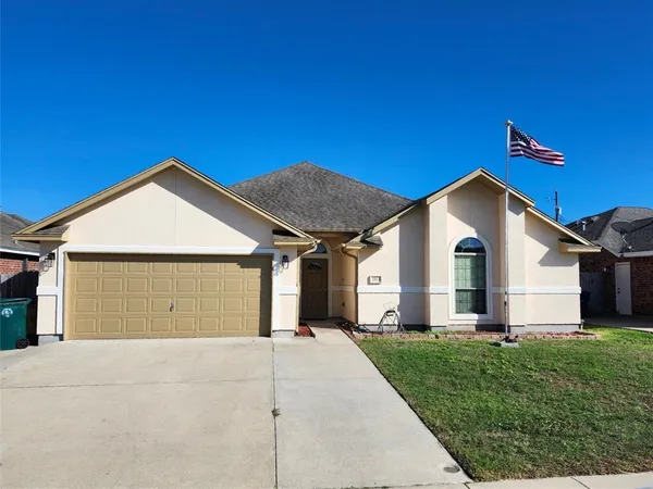 a view of a house with a yard and garage