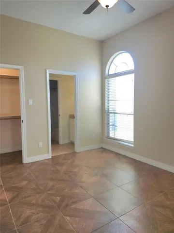 an empty room with windows and closet