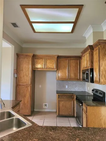 a kitchen with stainless steel appliances granite countertop a sink and a stove