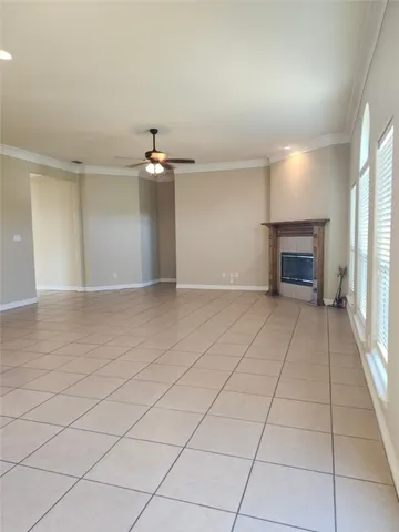 an empty room with a fireplace and windows