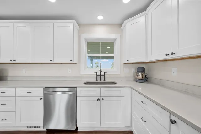 a front view of a house with a garden and plants