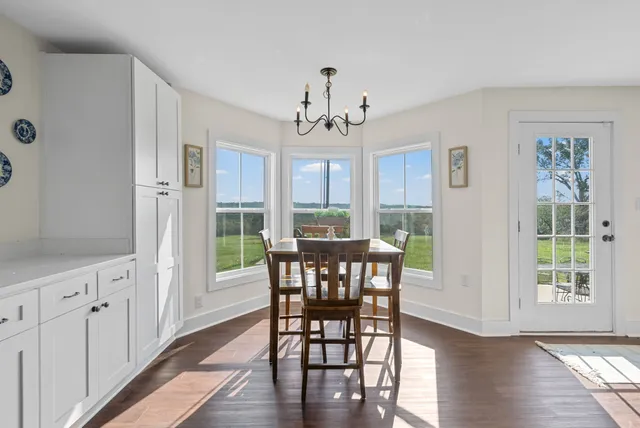 an aerial view of a house with a yard table and chairs