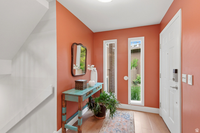3674 Oak Rim Way Salt Lake City, UT 84109 - Photo 5 of 47 Entryway featuring a paneled door, vertical sidelight windows, and wood-finish flooring