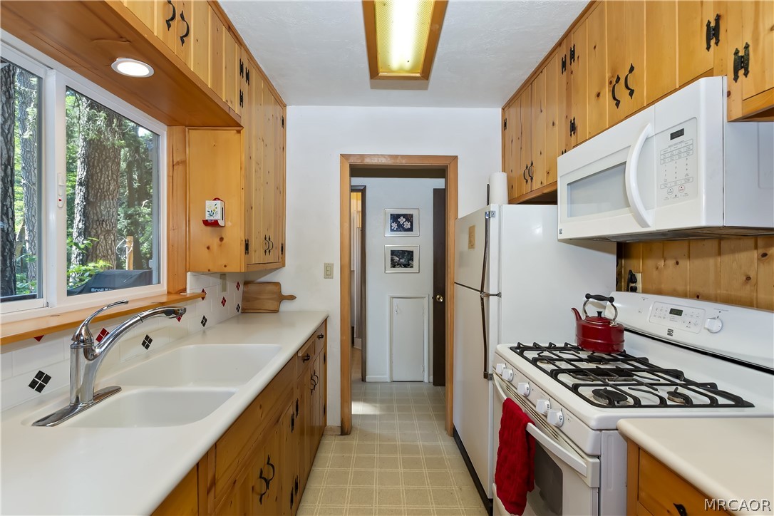 691 Cottage Grove Road Lake Arrowhead, CA 92352 - Photo 14 of 28 a kitchen that has a sink and a stove