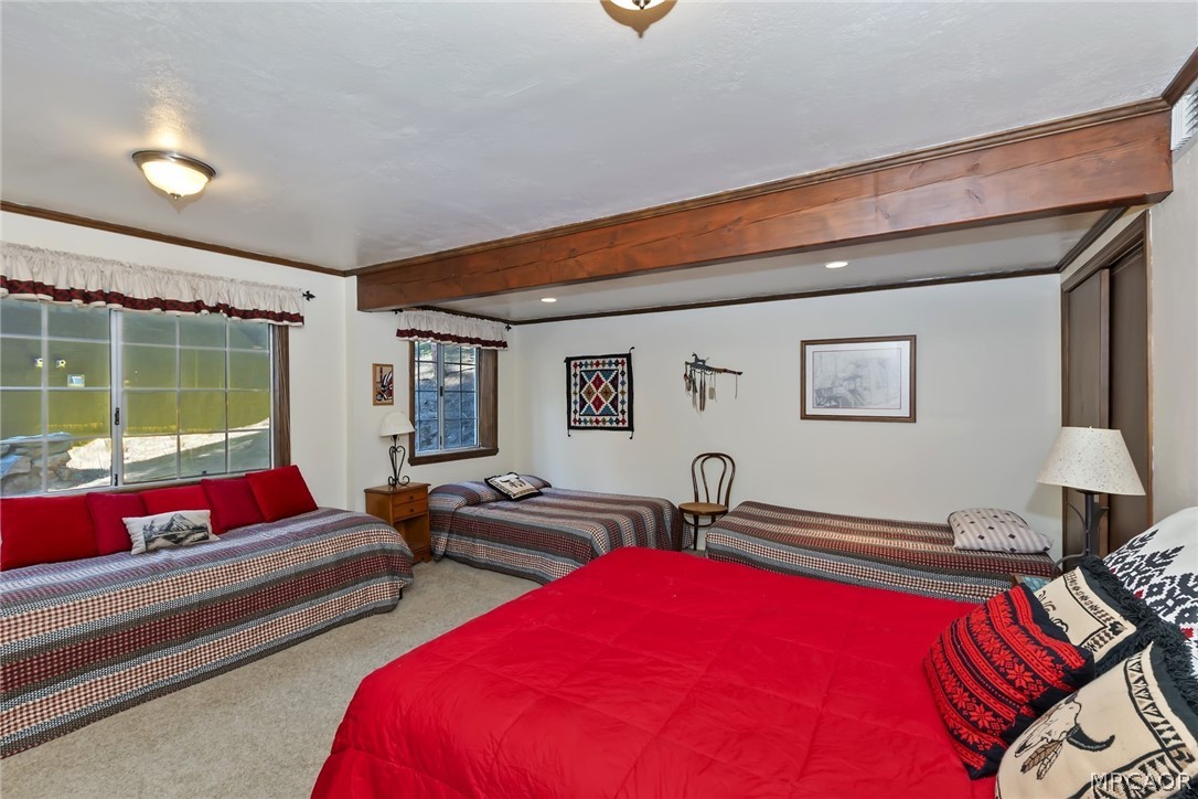 691 Cottage Grove Road Lake Arrowhead, CA 92352 - Photo 17 of 28 a living room with furniture a rug and a large window